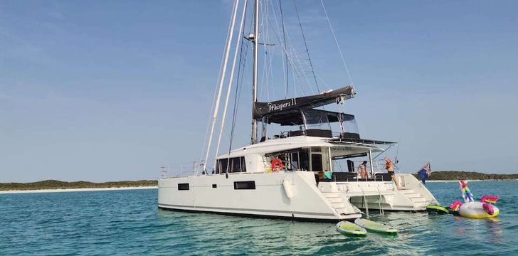 Whispers Catamaran Anchored With Toys and Inflatables