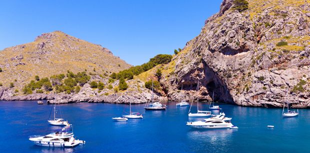 Sailing boats on the rugged coast of Mallorca