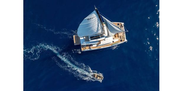 Aerial shot of the FARBEN yacht on blue waters
