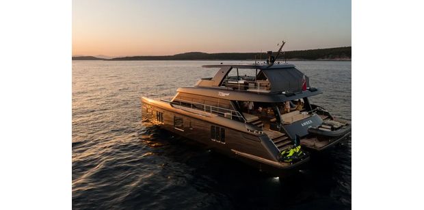 Rear view of AMBER ONE cruising across Adriatic waters during a sunset