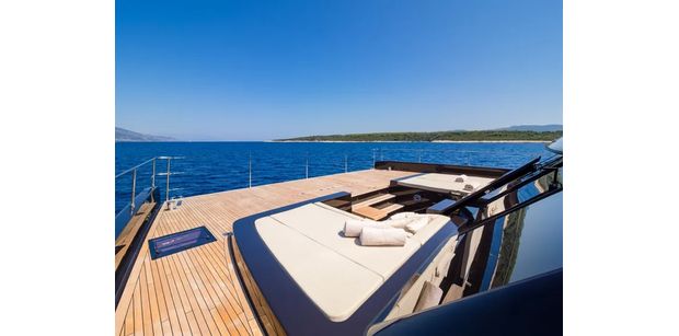 Spacious foredeck with sun beds and lounge seating overlooking the Adriatic Sea