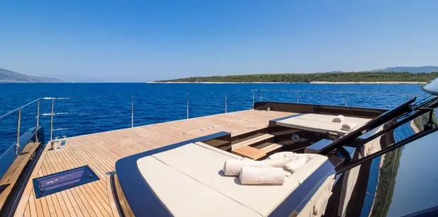 Spacious foredeck with sun beds and lounge seating overlooking the Adriatic Sea
