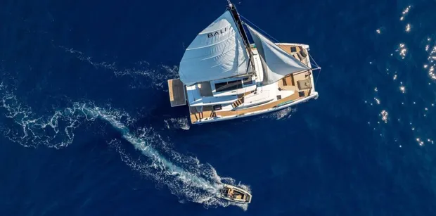 FARBEN aerial shot with full sails and tender