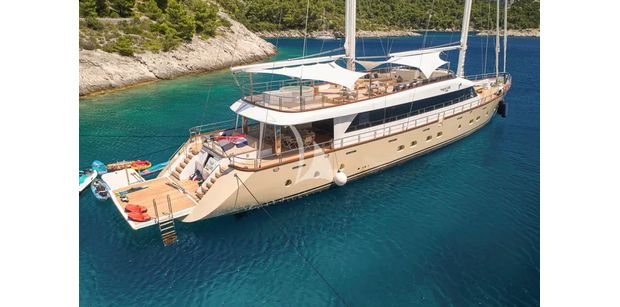 profile of superyacht marallure at anchor with water toys set out