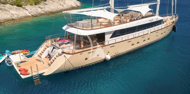 profile of superyacht marallure at anchor with water toys set out
