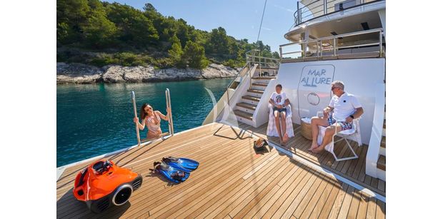 aft deck of marallure laid out with people enjoying water