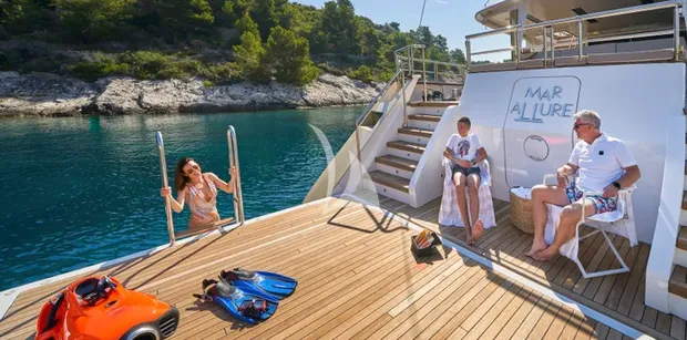 aft deck of marallure laid out with people enjoying water