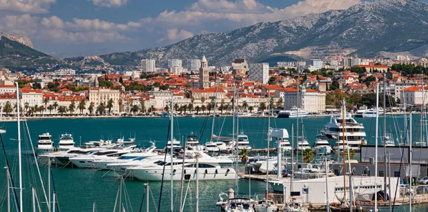 Split harbor with yachts and view of old town in background