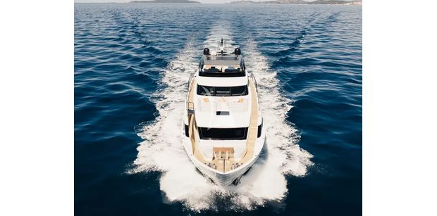 ZATARA II Sanlorenzo SL90A - front view of the ZATARA II motor yacht cruising through deep blue water, showing its elevated flybridge, sleek bow, teak side deck, and modern asymmetric design.