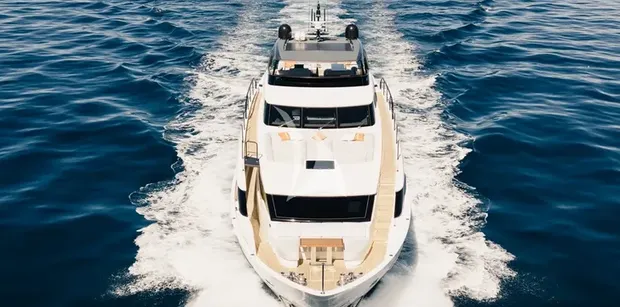 ZATARA II Sanlorenzo SL90A - front view of the ZATARA II motor yacht cruising through deep blue water, showing its elevated flybridge, sleek bow, teak side deck, and modern asymmetric design.