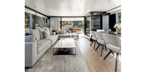 ZATARA II Sanlorenzo SL90A - main deck salon living room aboard ZATARA II, showing modern grey seating, floor-to-ceiling windows, and sliding doors to the outdoor deck