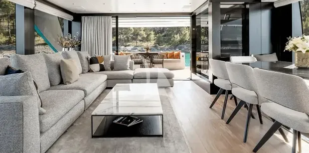 ZATARA II Sanlorenzo SL90A - main deck salon living room aboard ZATARA II, showing modern grey seating, floor-to-ceiling windows, and sliding doors to the outdoor deck