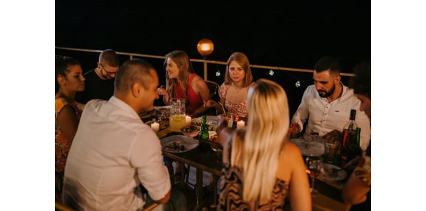 restaurant at night in croatia with courtyard seating and a group of cheerful diners