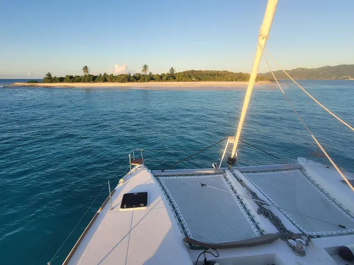 NEON MOON Lagoon 450 - foredeck view of an island NEON MOON Lagoon 450 - foredeck view of an island