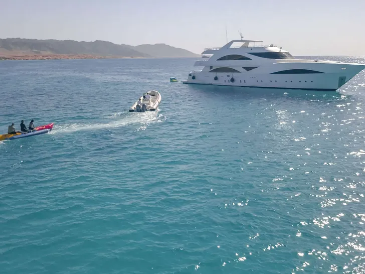 SEVEN SPICES 39-meter Custom Aluminum Cutter - anchored with tubing in the background SEVEN SPICES 39-meter Custom Aluminum Cutter - anchored with tubing in the background