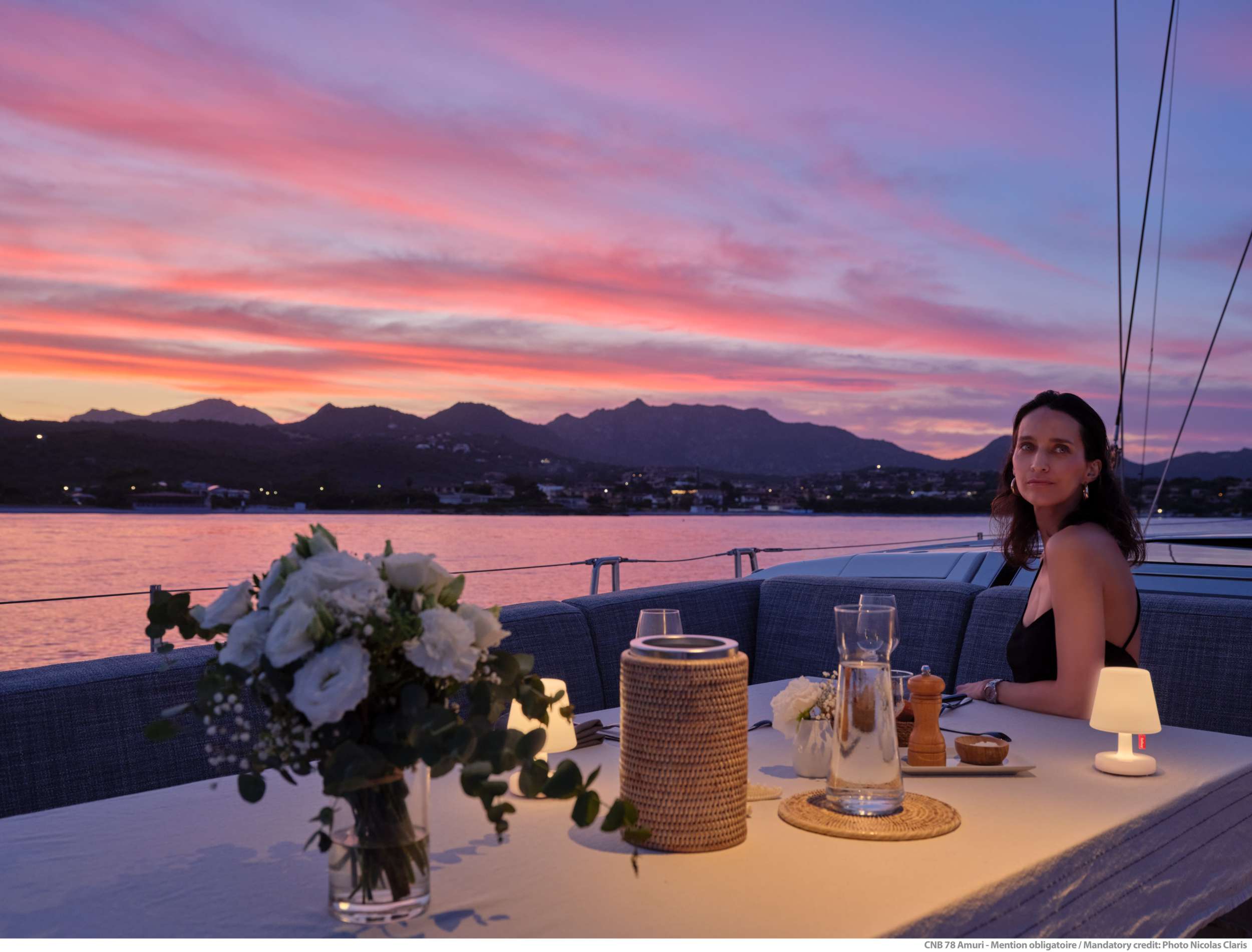 AMURI Solaris 24m - alfresco dining set up under the sunset