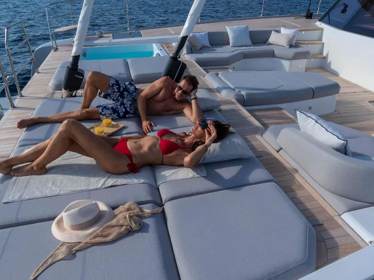 MAGIC MOMENTS 3 Fountaine Pajot Thira 80 - guests sunbathing MAGIC MOMENTS 3 Fountaine Pajot Thira 80 - guests sunbathing