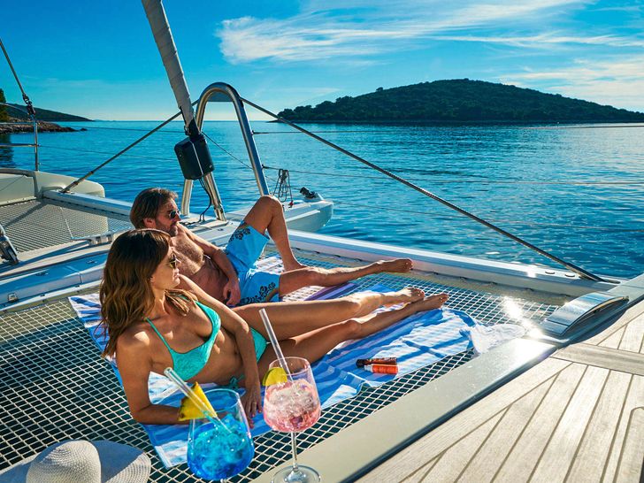 AMADA MIA Lagoon 65 - guest on the foredeck trampolines AMADA MIA Lagoon 65 - guest on the foredeck trampolines