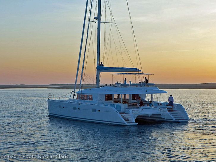 LADY M Lagoon 620 cruising under the sunset