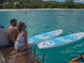 KARMA Lagoon 50 - guests on the swim platform with the paddleboards KARMA Lagoon 50 - guests on the swim platform with the paddleboards
