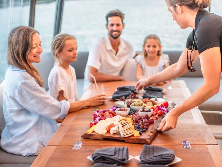 JUSTIFIED HORIZONS Lagoon 65 - guests dining alfresco JUSTIFIED HORIZONS Lagoon 65 - guests dining alfresco