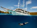 ALMISSA Custom Motor Yacht 40m - guest swimming beside the yacht ALMISSA Custom Motor Yacht 40m - guest swimming beside the yacht