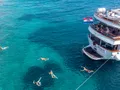 ALMISSA Custom Motor Yacht 40m - guests swimming in turquoise Adriatic water ALMISSA Custom Motor Yacht 40m - guests swimming in turquoise Adriatic water