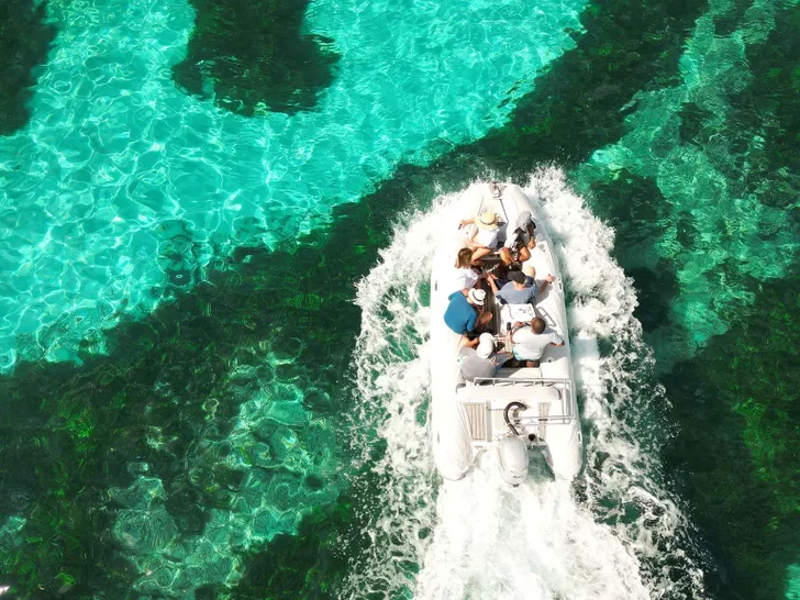 REVE2MER Lagoon 620 - dinghy cruising across the clear water REVE2MER Lagoon 620 - dinghy cruising across the clear water