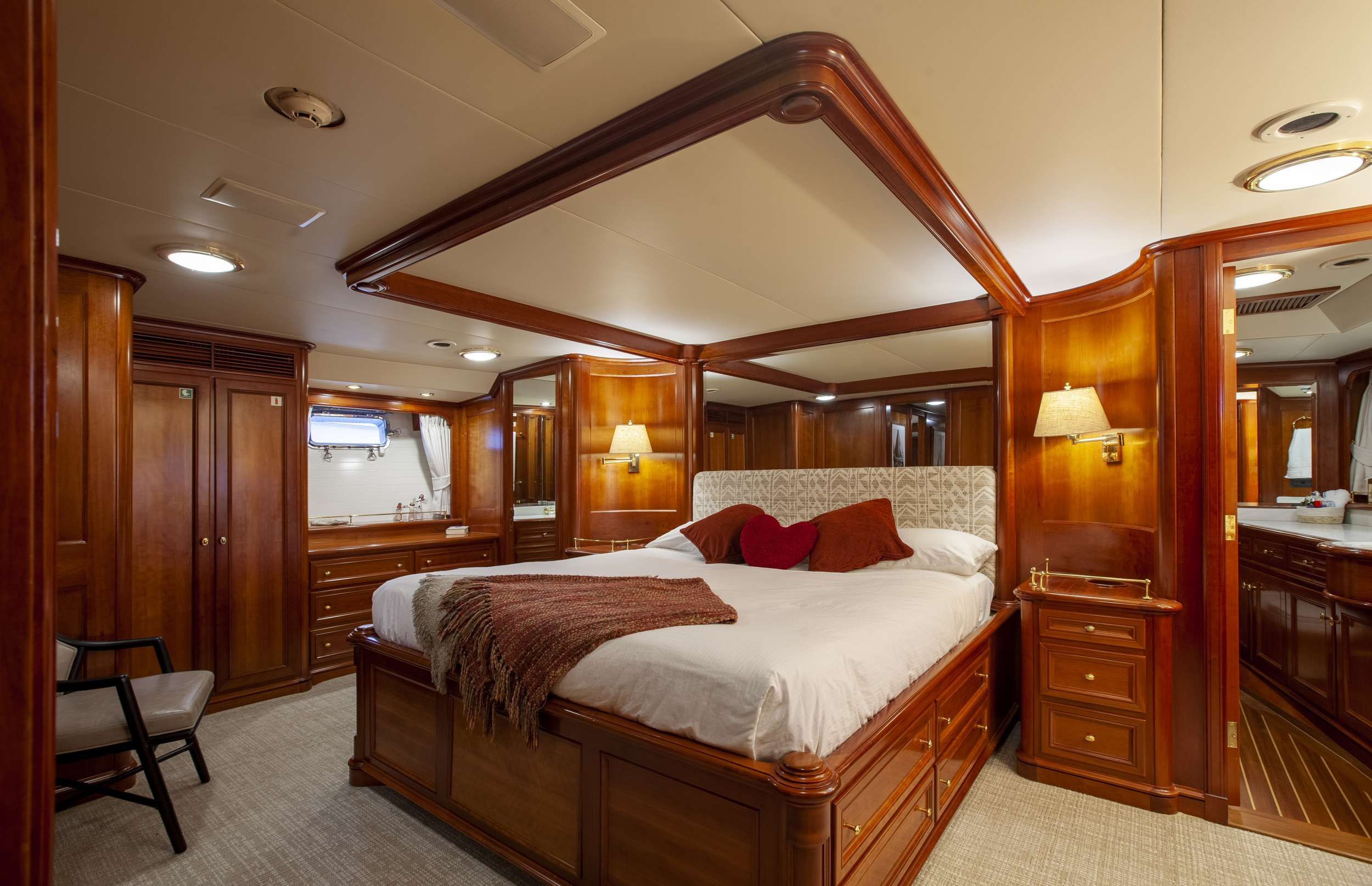 Master stateroom has king bed with separate his and her bathrooms and showers