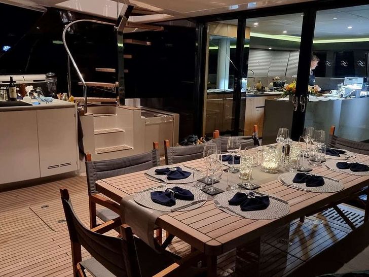 AMAYA Sunreef 60 - alfresco dining set up AMAYA Sunreef 60 - alfresco dining set up