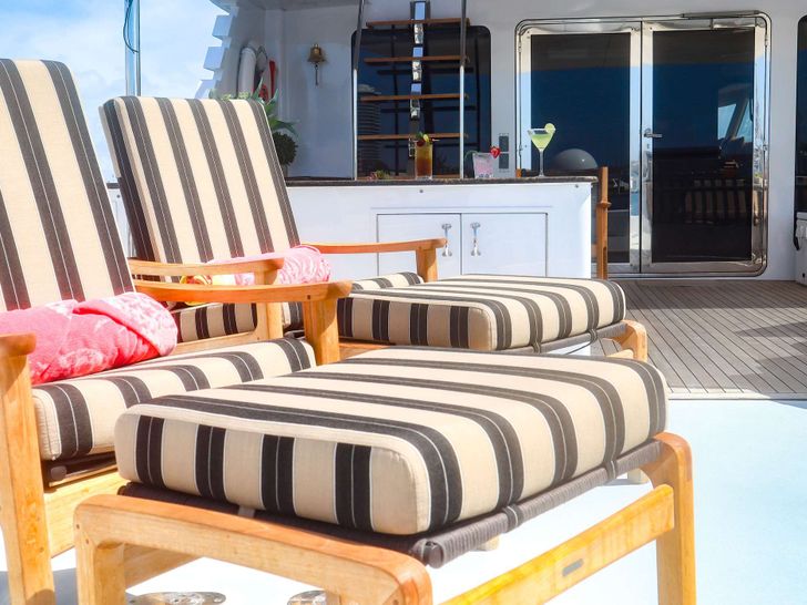LONE STAR Hatteras 130 Crewed Motor Yacht Sunbathing LONE STAR Hatteras 130 Crewed Motor Yacht Sunbathing