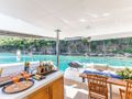 OLIVIA CHARLES Fountaine Pajot Ipanema 58 - aft deck kitchenette and dining table OLIVIA CHARLES Fountaine Pajot Ipanema 58 - aft deck kitchenette and dining table