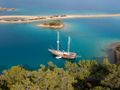 SERENAD A Custom Build 75 Gulet anchored near an island