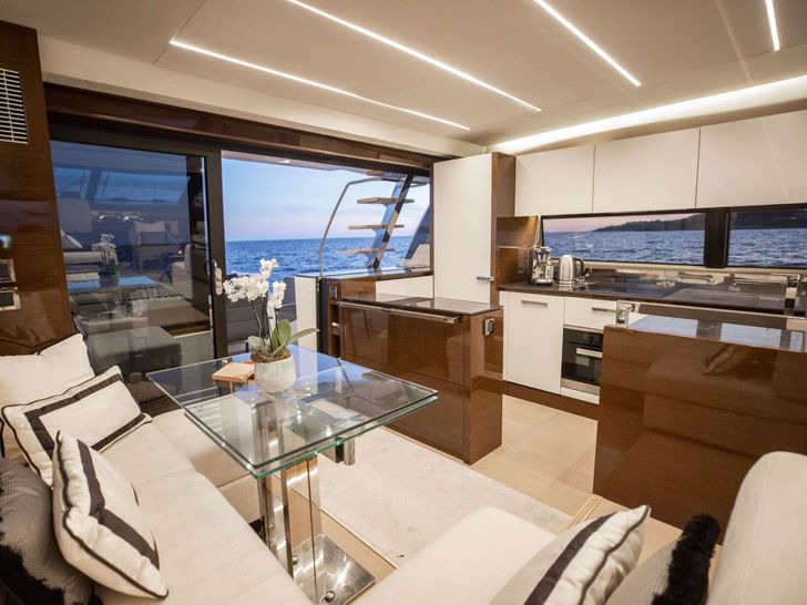 ROMY ONE Prestige 680 - saloon seating area and galley ROMY ONE Prestige 680 - saloon seating area and galley