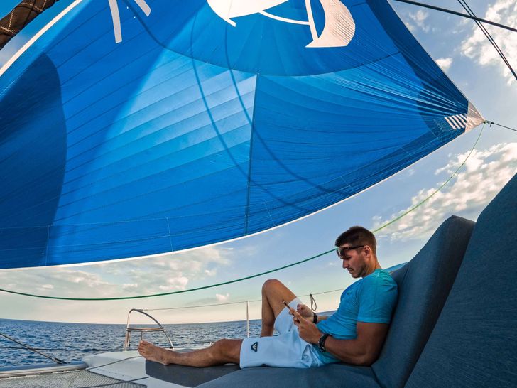 AMANTE Fountaine Pajot Saba 50 - guest lounging on the foredeck AMANTE Fountaine Pajot Saba 50 - guest lounging on the foredeck