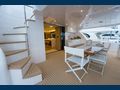 SALUS - Horizon 60,aft alfresco dining area with staircase to the flybridge