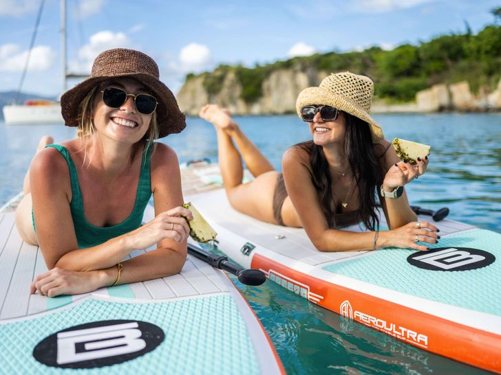 LIQUID SKY Fountaine Pajot Alegria 67 - guests on the paddleboard LIQUID SKY Fountaine Pajot Alegria 67 - guests on the paddleboard