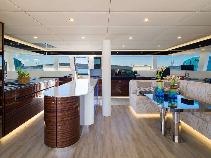 DESSUS Sunreef 60 - saloon seating and galley with a bar in the middle DESSUS Sunreef 60 - saloon seating and galley with a bar in the middle
