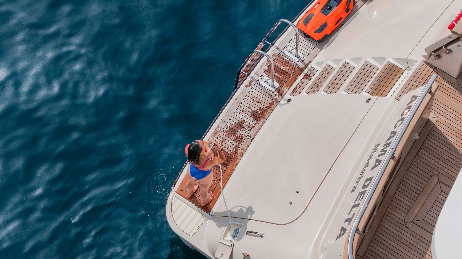 ACCAMA DELTA Azimut 30m - guest enjoying a freshwater shower on swim platform