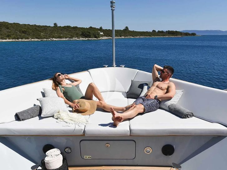 ANAVI Admiral 35 - guests sunbathing on the foredeck ANAVI Admiral 35 - guests sunbathing on the foredeck