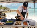 CROSSED SABRE Burger 144 chef preparing food by the beach CROSSED SABRE Burger 144 chef preparing food by the beach