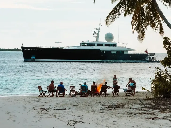 GALILEO Picchiotti 55.7m - beach set up with the yacht in background GALILEO Picchiotti 55.7m - beach set up with the yacht in background