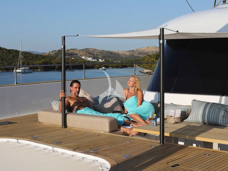 HONEYBIRD Sunreef 80 - guests lounging on the foredeck HONEYBIRD Sunreef 80 - guests lounging on the foredeck