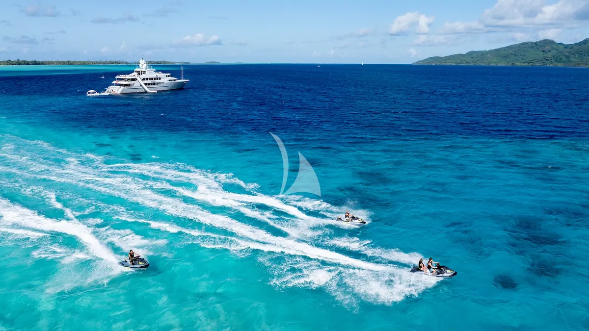 IRON BLONDE Trinity Yacht 60m - jet skis with yacht in background