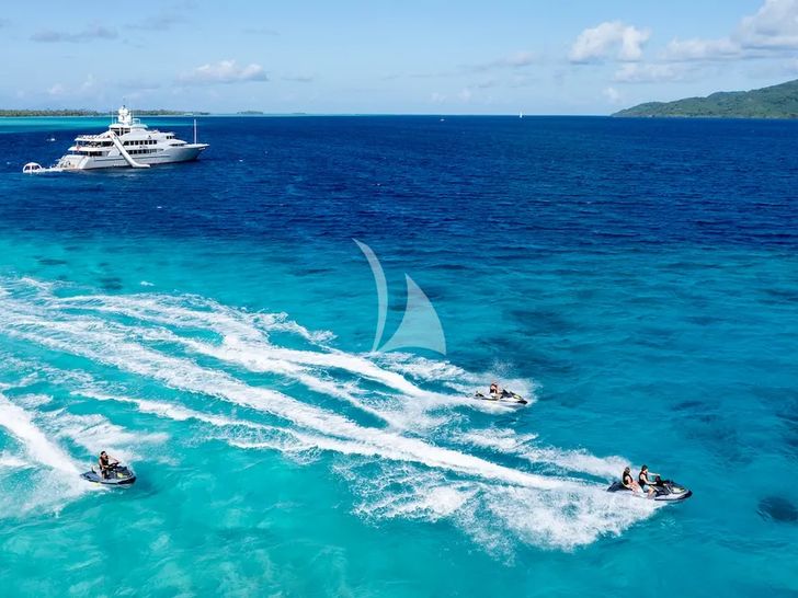 IRON BLONDE Trinity Yacht 60m - jet skis with yacht in background IRON BLONDE Trinity Yacht 60m - jet skis with yacht in background