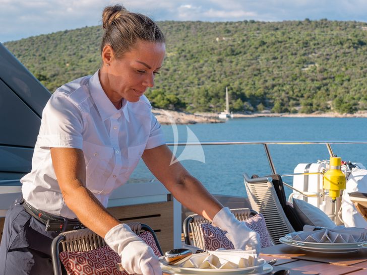 JOURNEY - Sanlorenzo SL102,stewardess preparing dinner on the sky deck