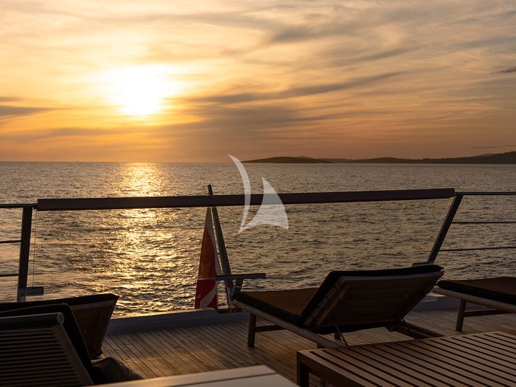 JOURNEY Sanlorenzo SL102 - alfresco seating area under the sunset JOURNEY Sanlorenzo SL102 - alfresco seating area under the sunset