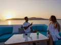 KAYRA Phinisi 38m - guests lounging on the sundeck under the sunset KAYRA Phinisi 38m - guests lounging on the sundeck under the sunset