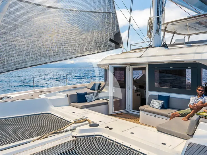 LINDA Lagoon 60 - guest unwinding on the foredeck lounge LINDA Lagoon 60 - guest unwinding on the foredeck lounge