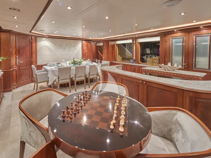 MAMMA MIA Benetti Classic 120 - main saloon bar and gaming table MAMMA MIA Benetti Classic 120 - main saloon bar and gaming table